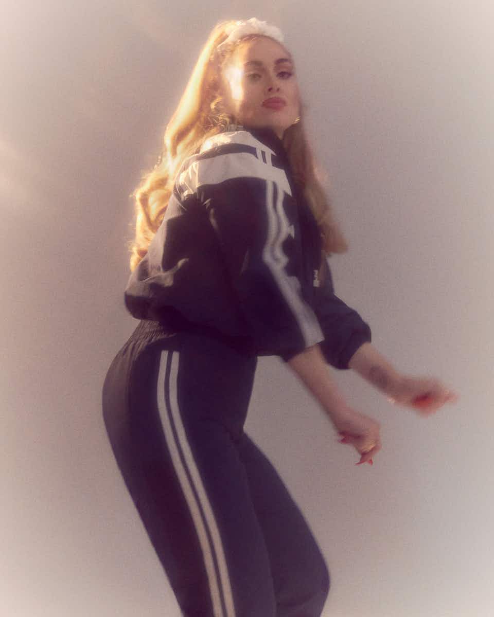 Adele is wearing a Balenciaga tracksuit and earrings by Moya. Her hair is tied up in a scrunchie. Shot by Charlotte Wales for The Face Magazine. Published in November 2021, ahead of her new album '30'